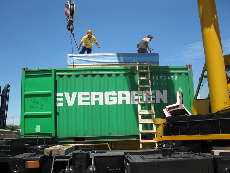 Popular Pack workers are doing final checking on top of a container.